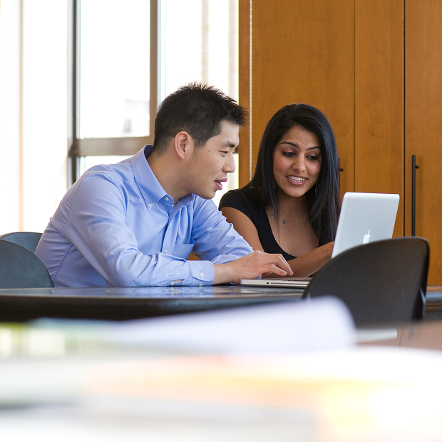 man and woman working on a laptop